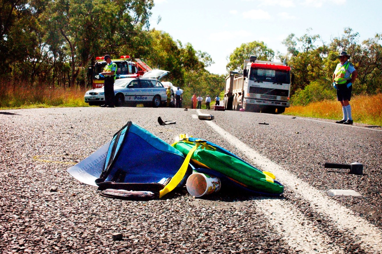 Debris lies scattered across the Bruce Highway near Gladstone 500km after a serious collision on the two-lane section of our national highway.
(AAP Image) 