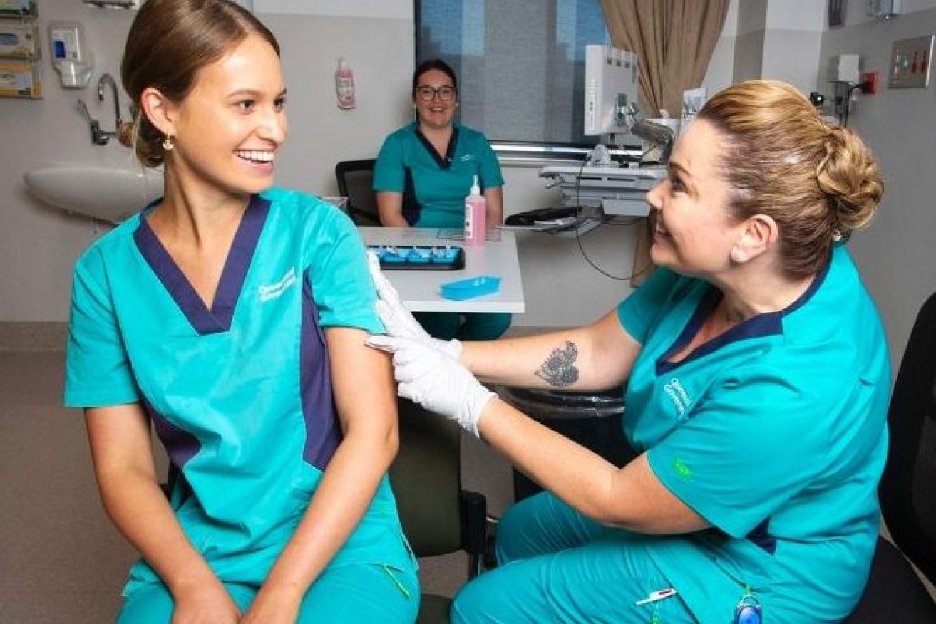 The first COVID-19 vaccine has been given in Queensland with nurse Zoe Park receiving the jab at the Gold Coast University Hospital.(AAP: Nigel Hallett)