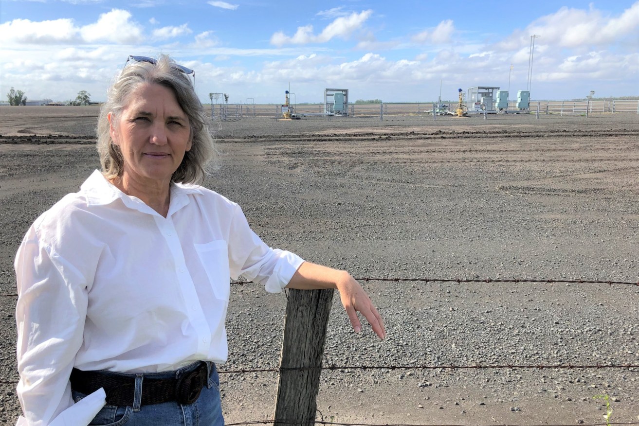 Dalby cotton grower Zena Ronnfeldt with CSG wells in the background.