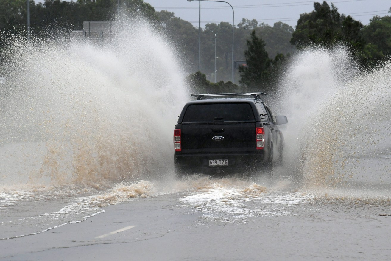 The weather bureau is warning of heavy rain and dangerous surf across much of south-east Queensland in a soggy end to the Easter break. (AAP Image/Dave Hunt) 