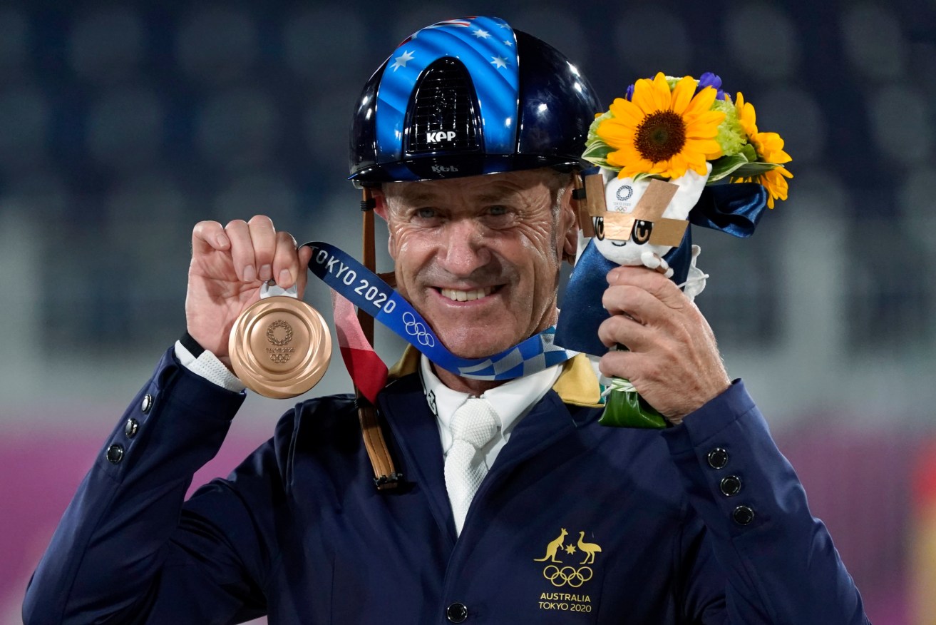 Australia's Andrew Hoy displays his bronze medal he won in the equestrian eventing jumping individual final at Equestrian Park in Tokyo at the 2020 Summer Olympics, Monday, Aug. 2, 2021, in Tokyo, Japan. (AP Photo/Carolyn Kaster)
