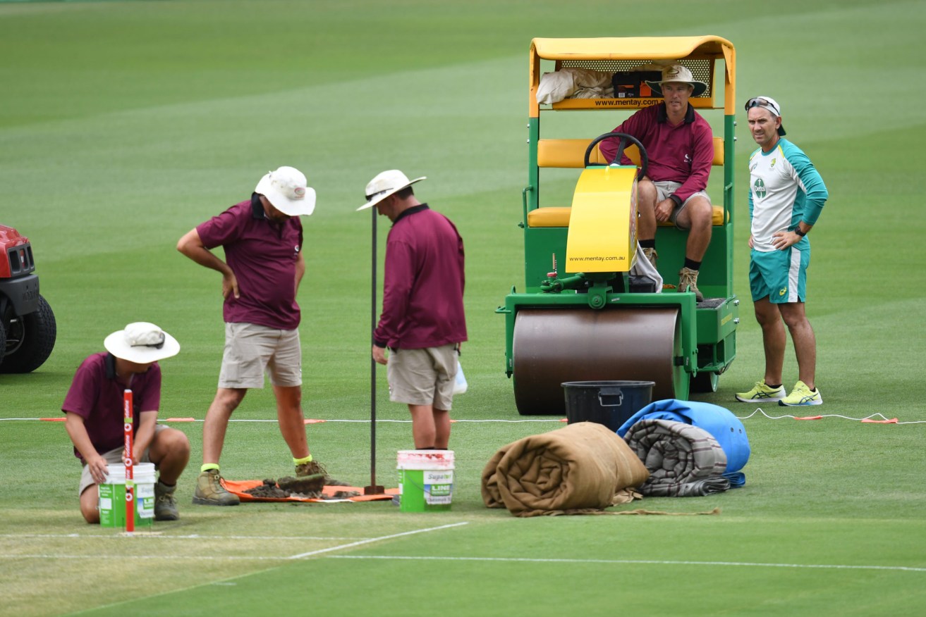 Australian coach Justin Langer (right)] is seen talking to Gabba head curator David Sandurski (2nd from right) during preparations for the First Ashes Test at the Gabba on Wednesday . (AAP Image/Darren England) 
