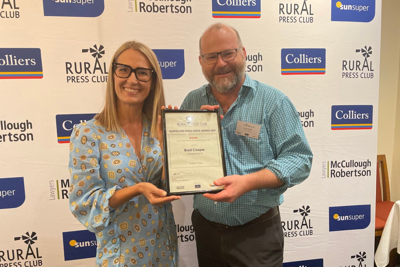 InQueensland journalist Brad Cooper accepts his award from Rural Press Club president Stacey Wordsworth.