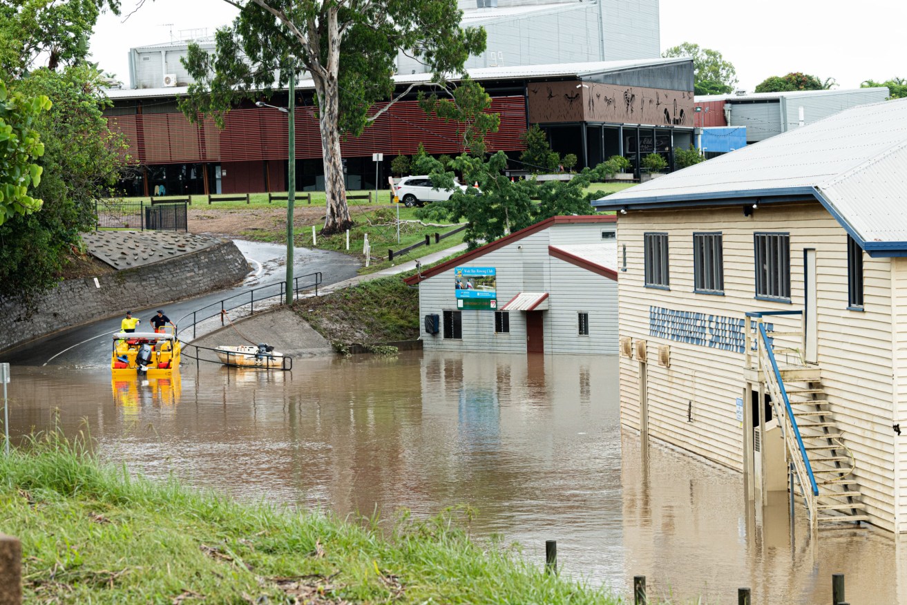 Council workers clean up damage caused by floodwaters in Maryborough, 220km north of Brisbane, Tuesday. More than 30 inner-city blocks were issued with an evacuation order after the remnants of tropical cyclone Seth dumped 600mm of rain on the Wide Bay-Burnett region in two days. (AAP Image/Paul Beutel) 