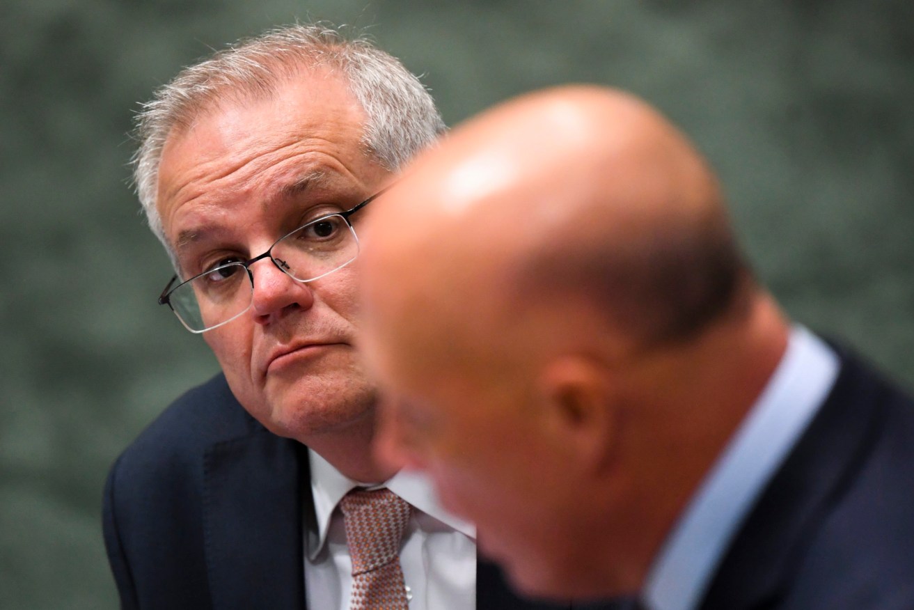 Australian Prime Minister Scott Morrison (left) listens to Australian Defence Minister Peter Dutton during Question time. (AAP Image/Lukas Coch) 