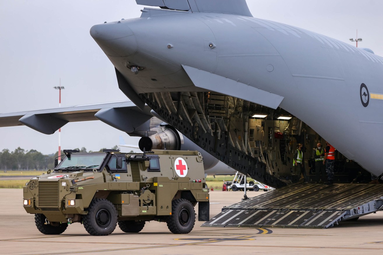 A Bushmaster PMV is loaded into a C-17 Globemaster which is headed for Ukraine. (AAP Image/Russell Freeman)