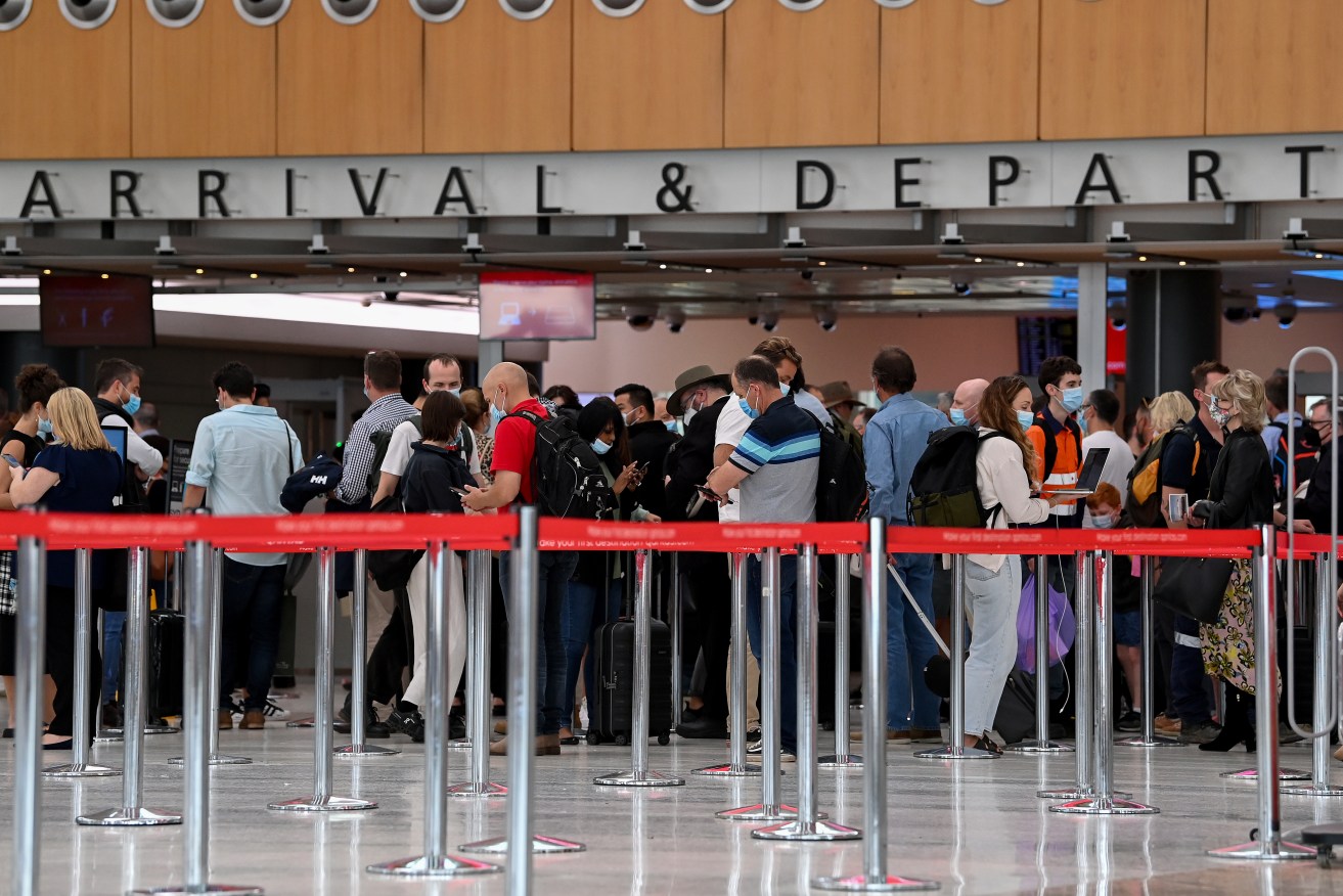 Queues of people are seen at the Qantas departure terminal at at Sydney Domestic Airport in Sydney, Wednesday, April 13, 2022. (AAP Image/Bianca De Marchi) NO ARCHIVING