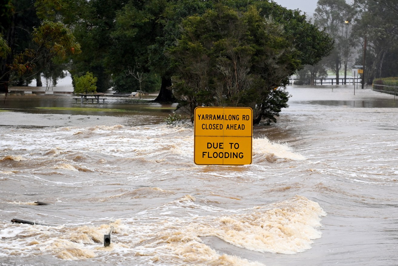 Floodwaters flow through Yarramalong cutting off the town on the Central Coast, north of Sydney. NSW residents are bracing for more heavy rain and flooding as dangerous downpours continue throughout the day. (AAP Image/Jeremy Piper) 