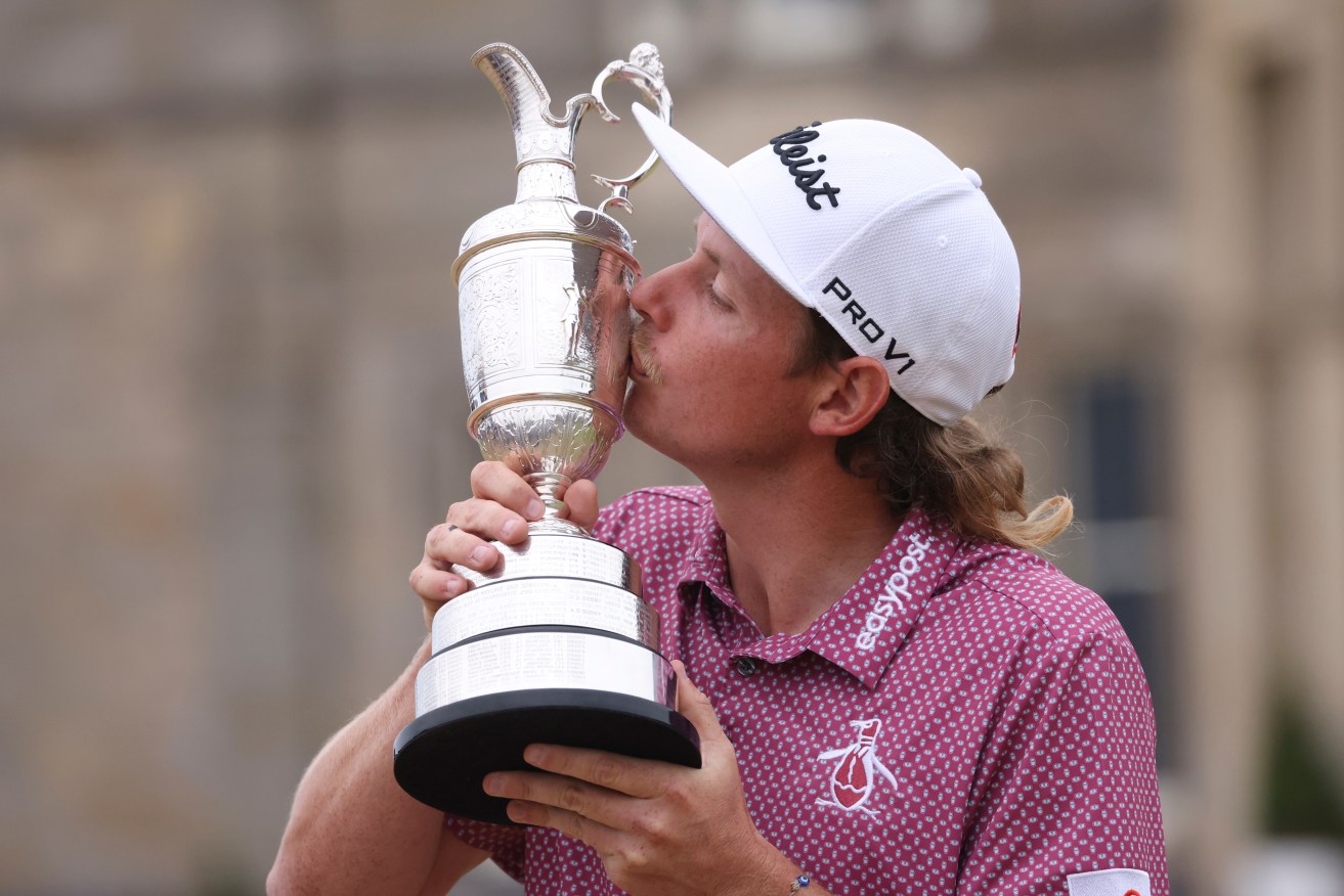 Queenslander Cameron Smith, of Australia, kisses the claret jug trophy as he poses for photographers on the 18th green after winning the British Open golf Championship on the Old Course at St. Andrews, Scotland, (AP Photo/Peter Morrison)