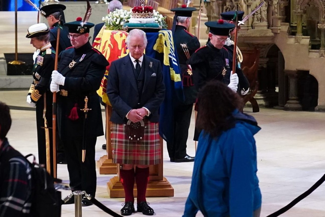 Britain's King Charles III, center, and other members of the royal family hold a vigil at the coffin of Queen Elizabeth II at St Giles' Cathedral, Edinburgh, Scotland,  Monday Sept. 12, 2022, as members of the public walk past. (Jane Barlow/Pool via AP)